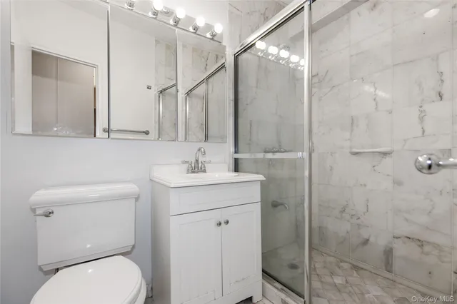 a bathroom with a toilet sink and shower