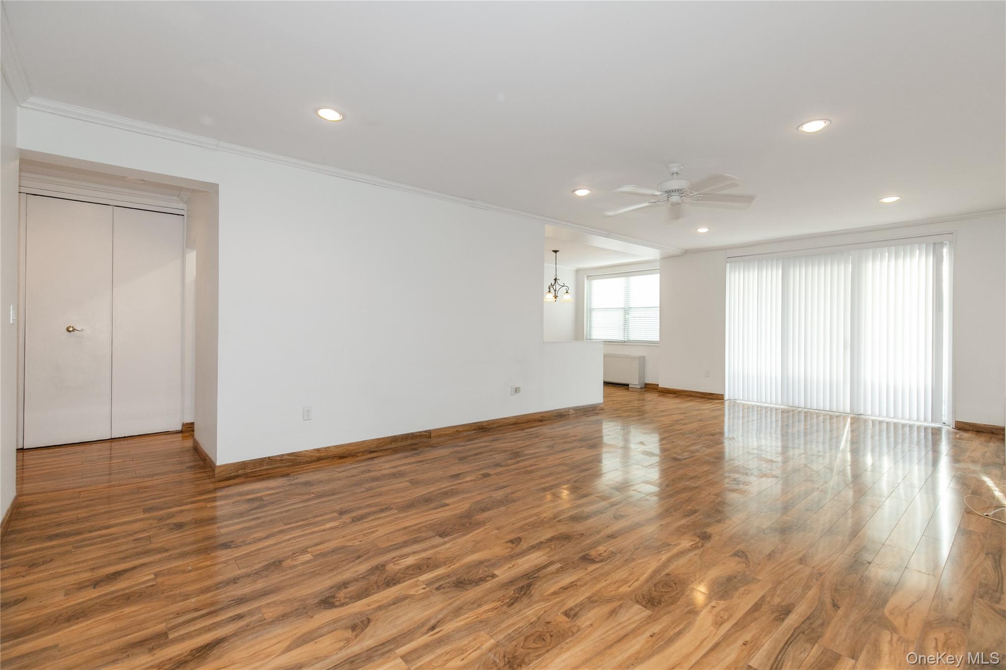 1 Kensington Gate, Unit 302 Great Neck, NY 11021 - Photo 5 of 30 a view of empty room with wooden floor and window
