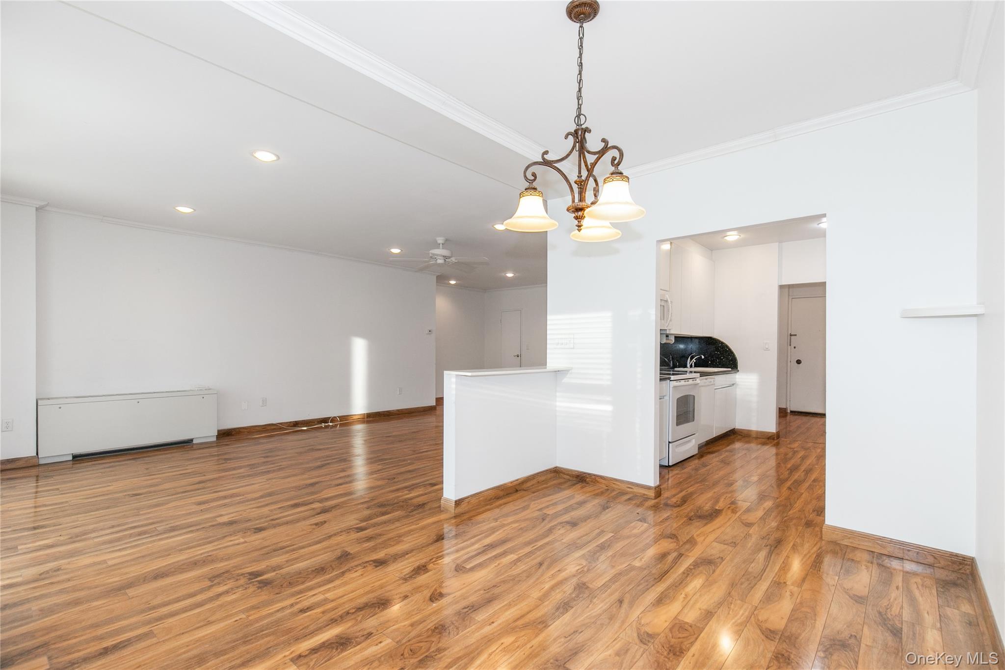 1 Kensington Gate, Unit 302 Great Neck, NY 11021 - Photo 7 of 30 a view of a kitchen with a sink stainless steel appliances and a chandelier