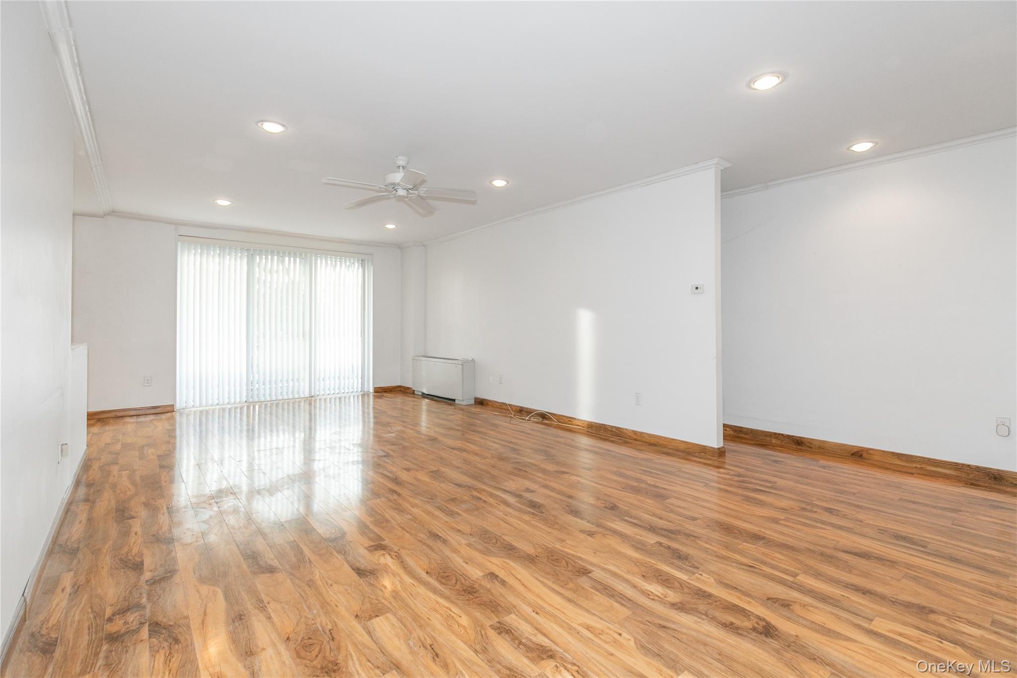 1 Kensington Gate, Unit 302 Great Neck, NY 11021 - Photo 8 of 30 a view of empty room with wooden floor and fan