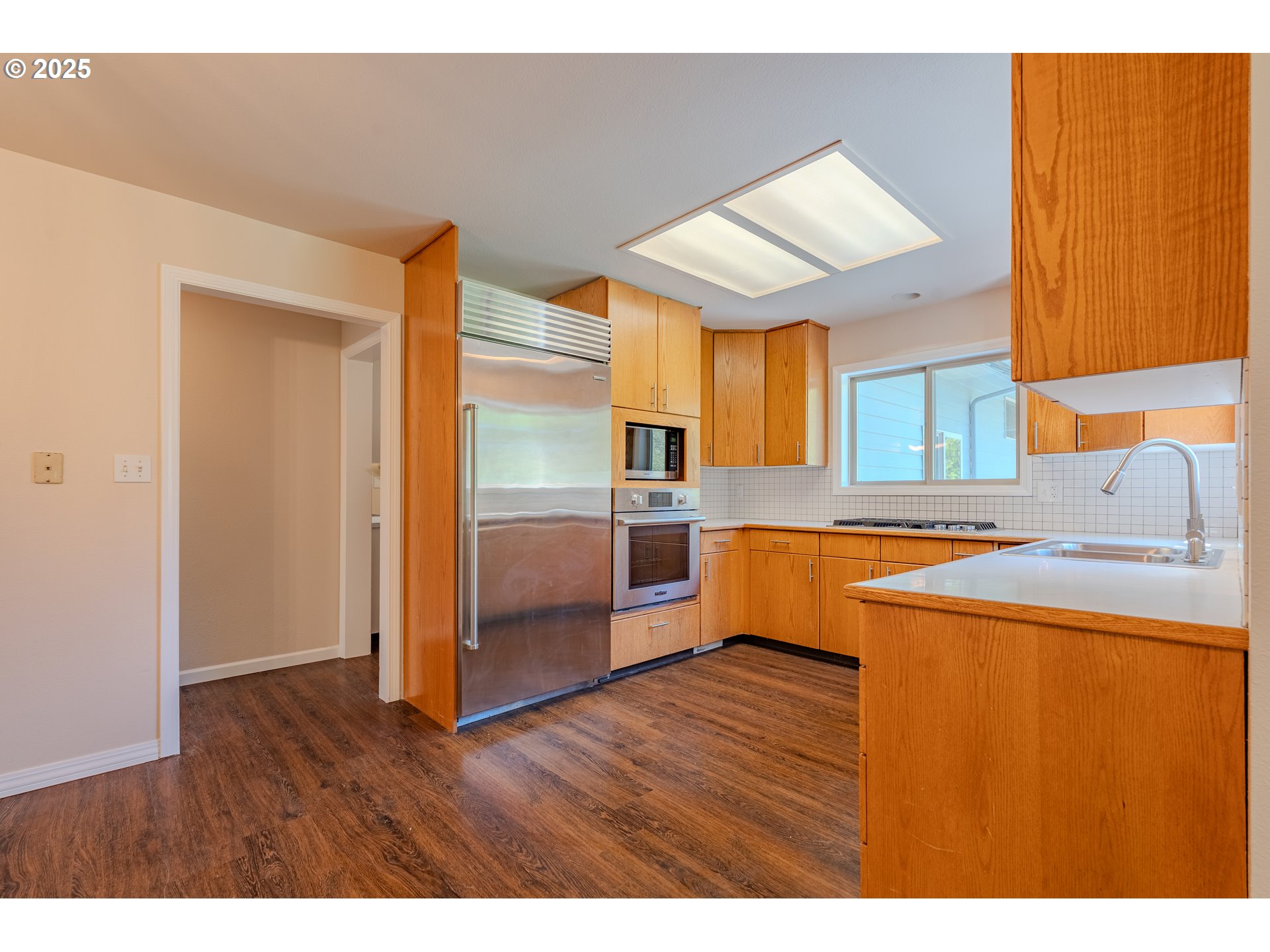 2126 Northeast 194th Street Ridgefield, WA 98642 - Photo 13 of 44 a kitchen with stainless steel appliances a refrigerator and a sink
