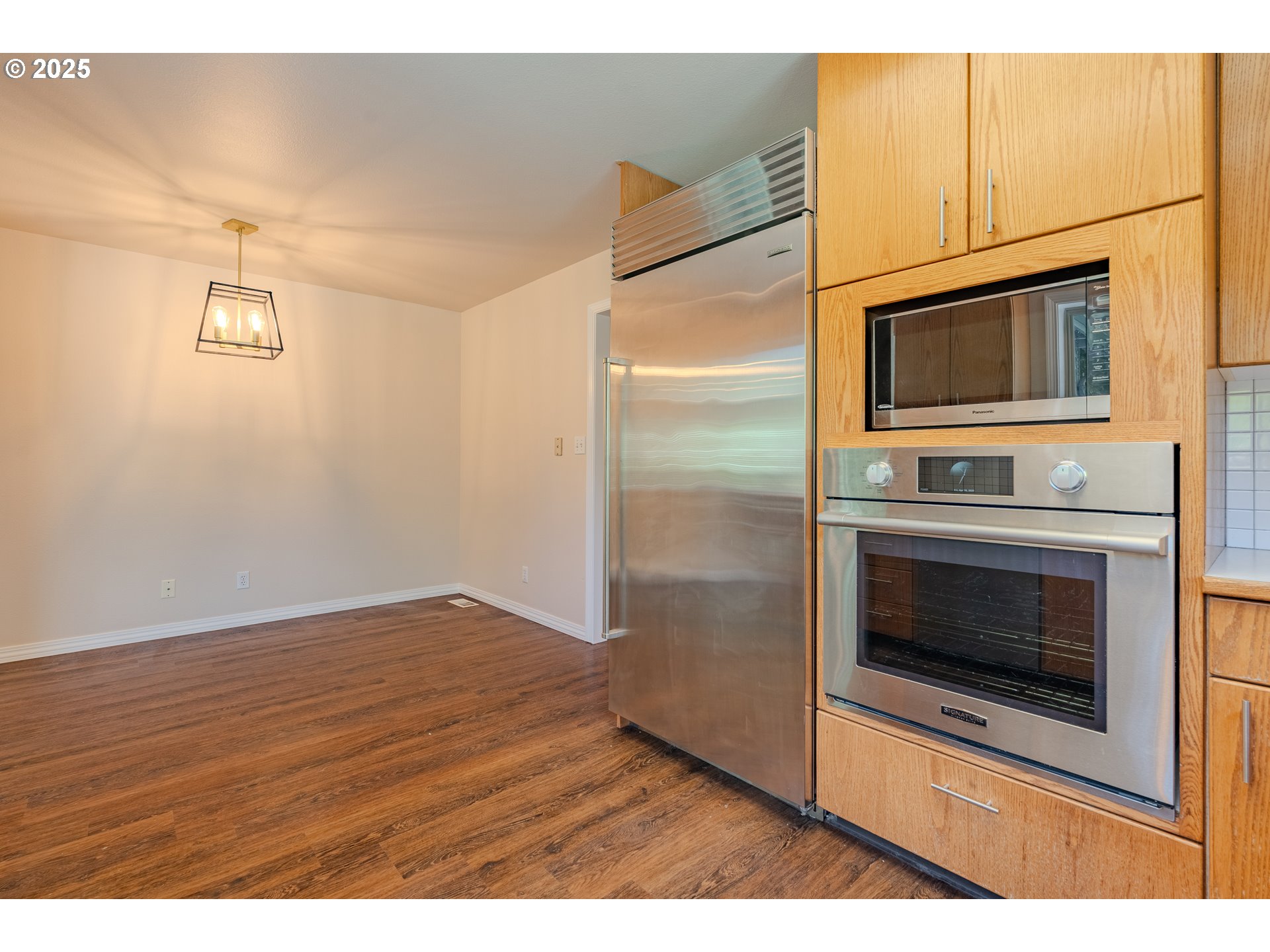 2126 Northeast 194th Street Ridgefield, WA 98642 - Photo 16 of 44 a kitchen with granite countertop a stove and a microwave