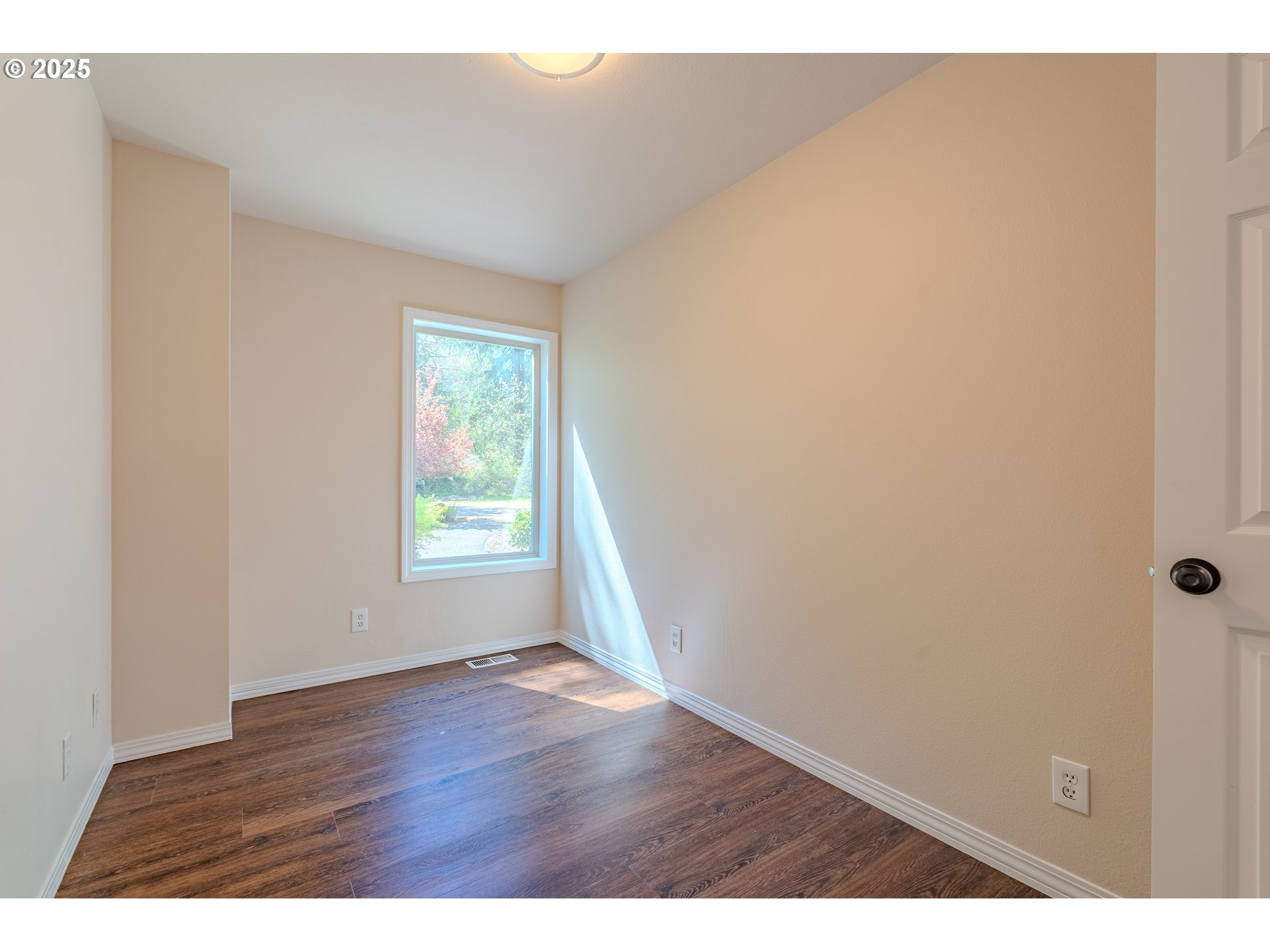 2126 Northeast 194th Street Ridgefield, WA 98642 - Photo 20 of 44 a view of an empty room with wooden floor and a window