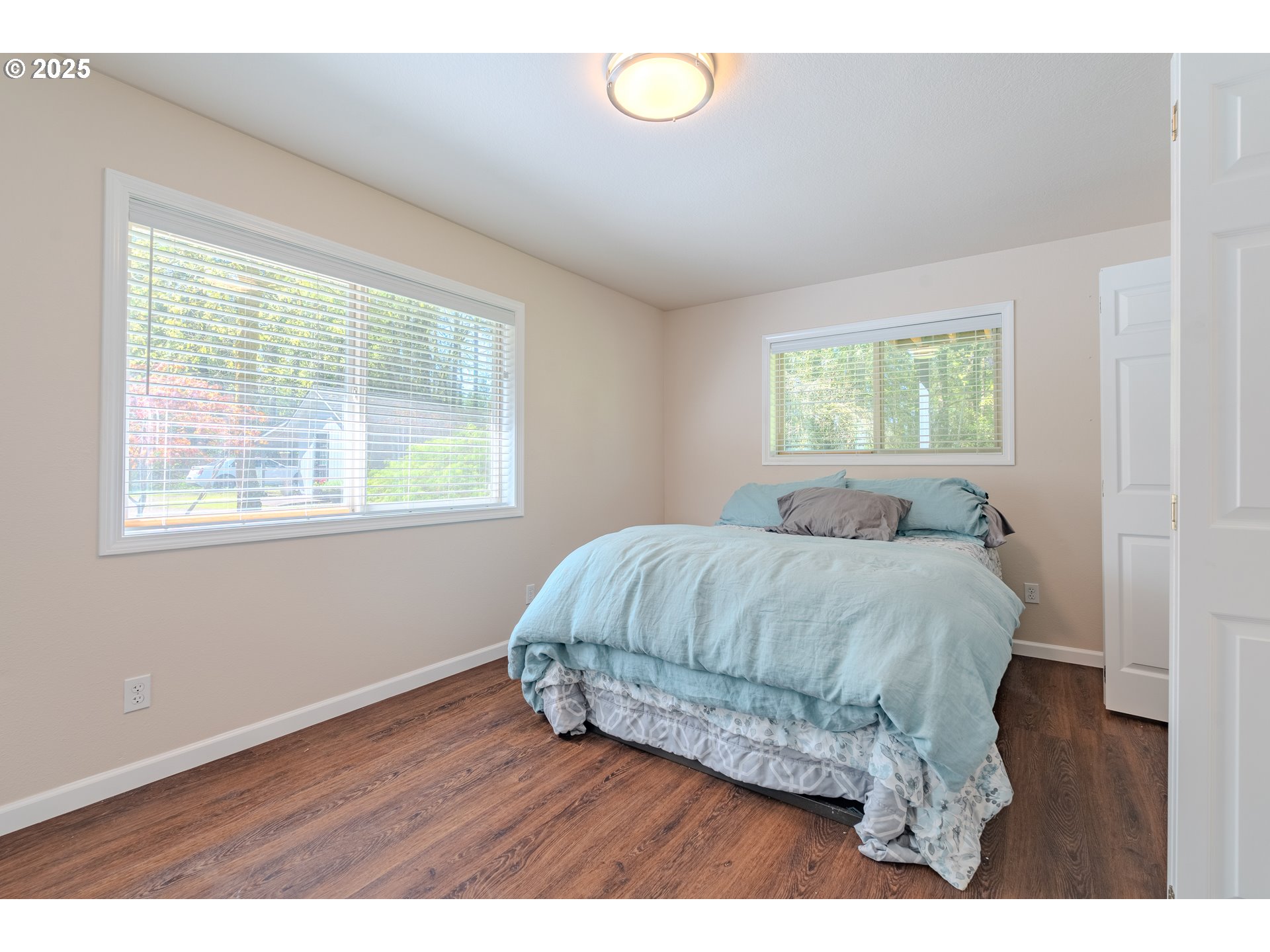 2126 Northeast 194th Street Ridgefield, WA 98642 - Photo 29 of 44 a bedroom with a bed and windows