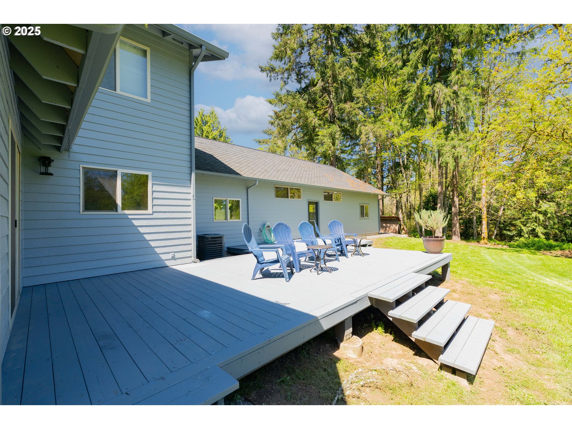 2126 Northeast 194th Street Ridgefield, WA 98642 - Photo 6 of 44 a view of a patio with table and chairs with wooden floor and fence