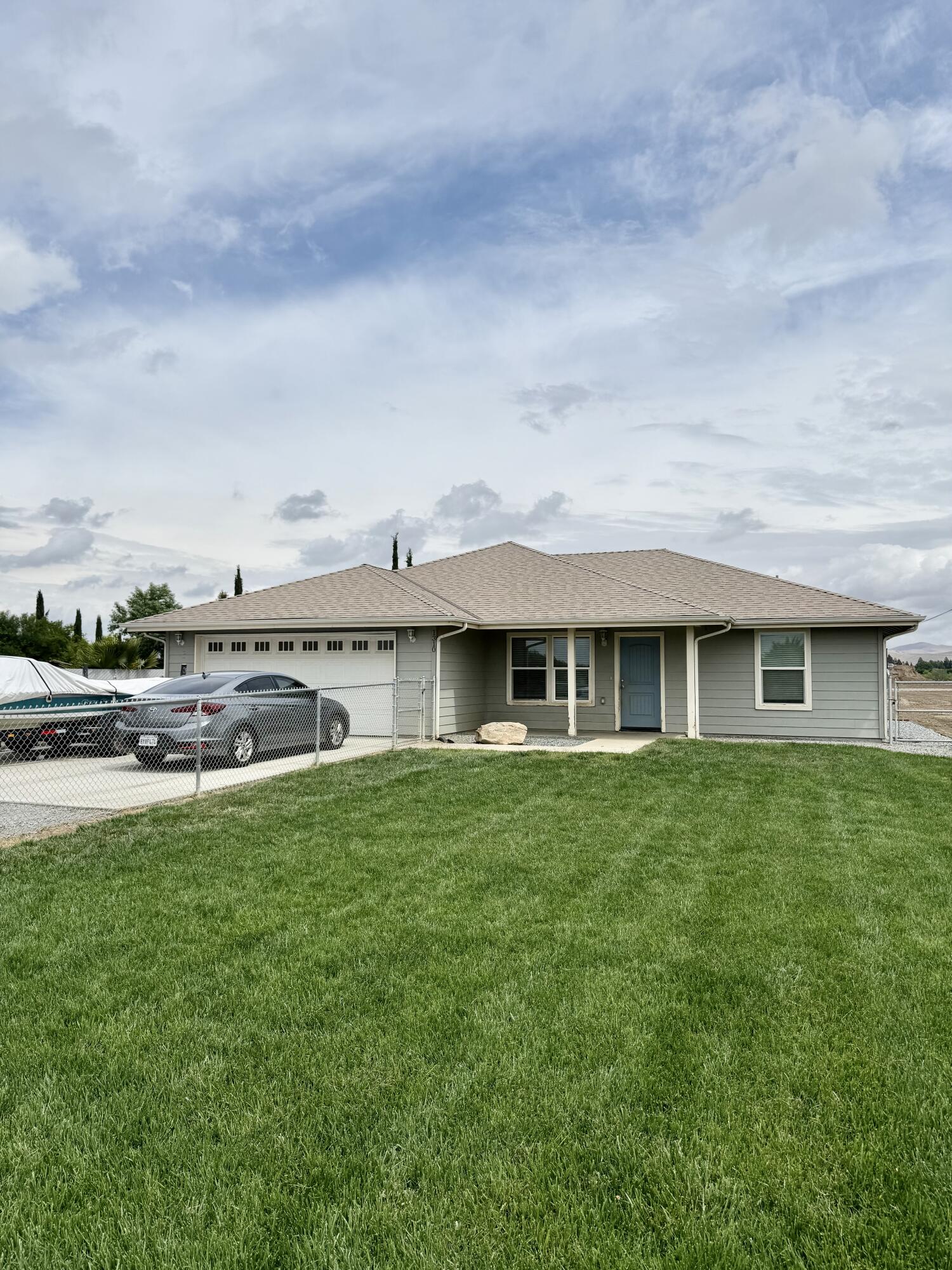 1310 North Belmont Road Exeter, CA 93221 - Photo 1 of 15 a view of a house with a garden and a yard