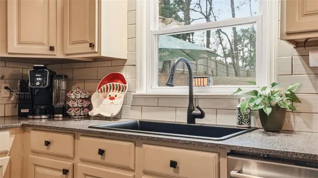 a kitchen with stainless steel appliances kitchen island granite countertop a refrigerator and a stove