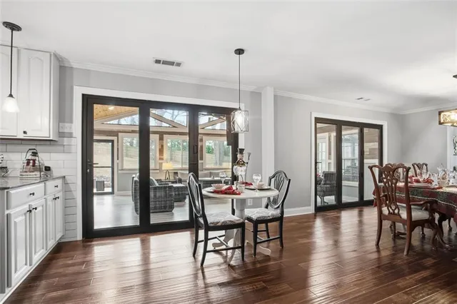 a front view of a house with a yard and trees