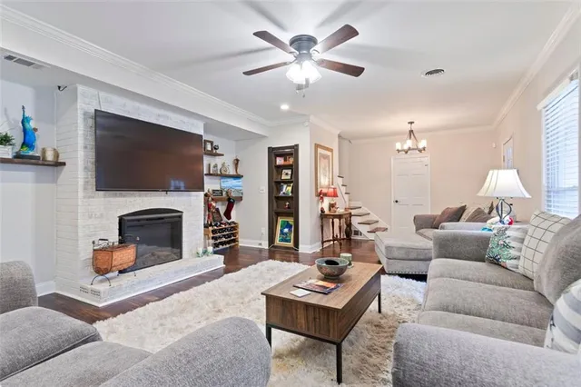 a kitchen with granite countertop white cabinets and stainless steel appliances