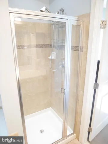 a bathroom with a glass shower door