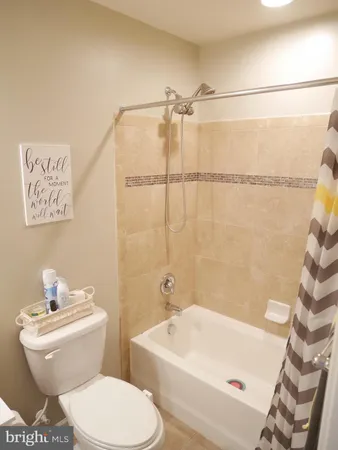 a white toilet sitting next to a bathroom sink