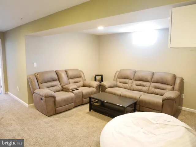 a living room with couches and painted walls