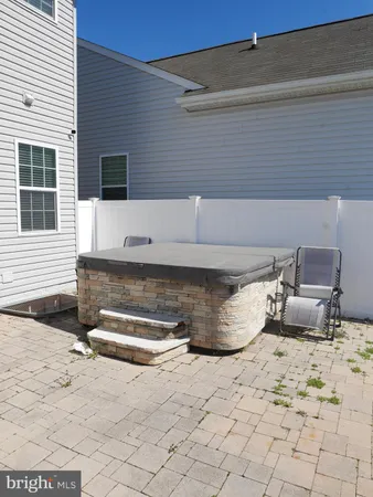 a view of a patio with a chair and potted plants