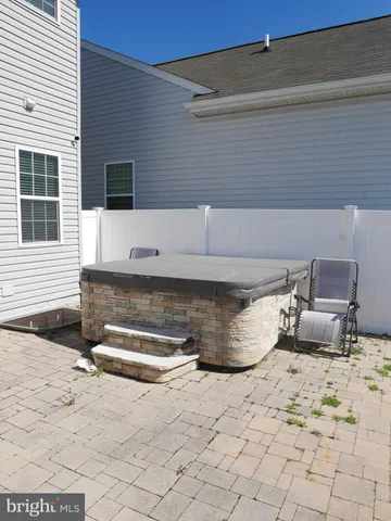 a view of a patio with a chair and potted plants