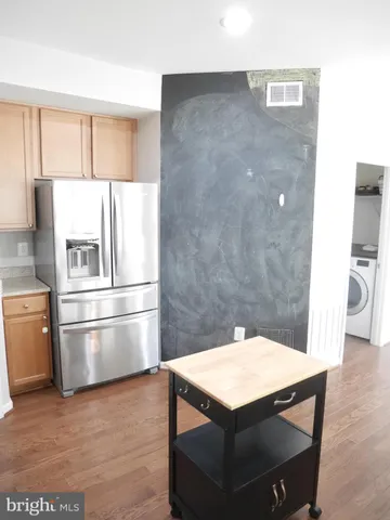 a kitchen with stainless steel appliances kitchen island a refrigerator sink and stove