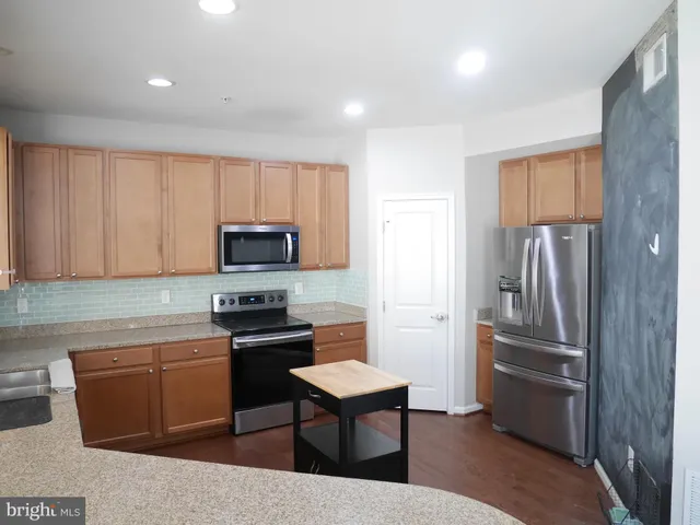 a kitchen with cabinets and stainless steel appliances
