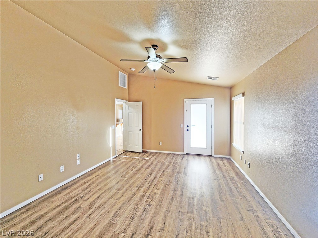 3680 Ravine Avenue Pahrump, NV 89048 - Photo 13 of 28 Unfurnished room featuring wood finished floors, visible vents, baseboards, and ceiling fan