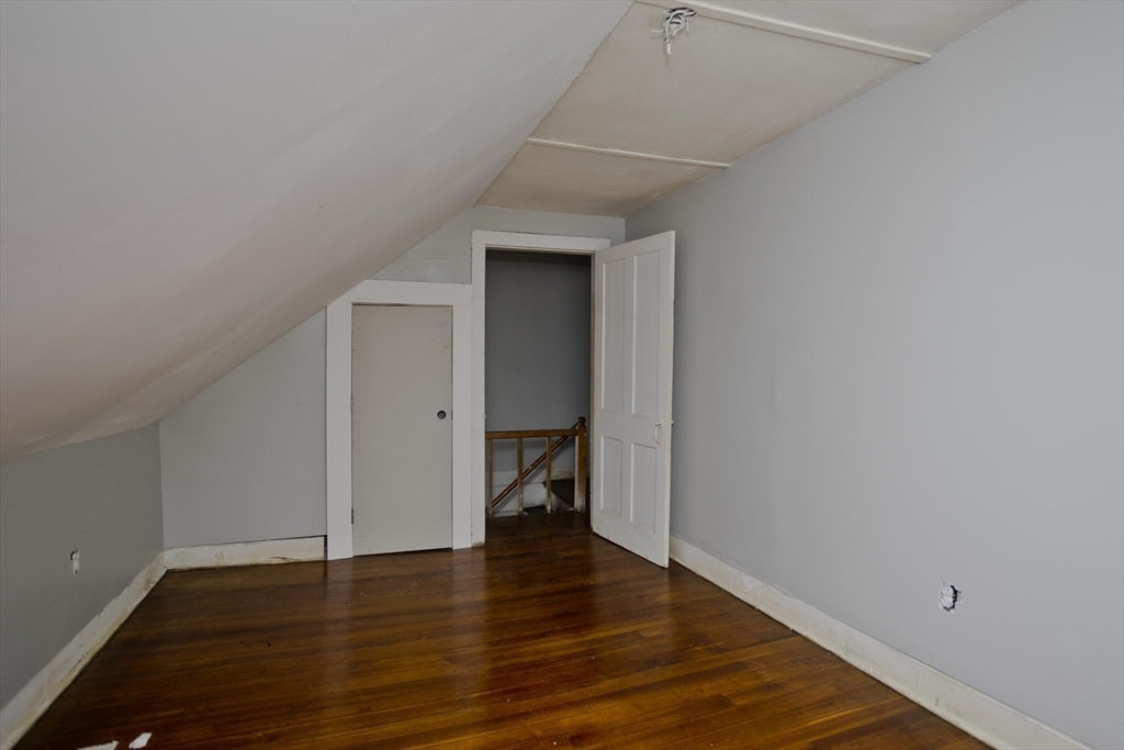 293-295 Water Street Springfield, MA 01151 - Photo 17 of 36 a view of an empty room with wooden floor and closet