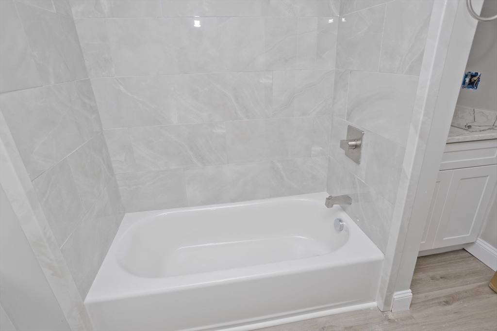293-295 Water Street Springfield, MA 01151 - Photo 25 of 36 a white bath tub sitting next to a white wall
