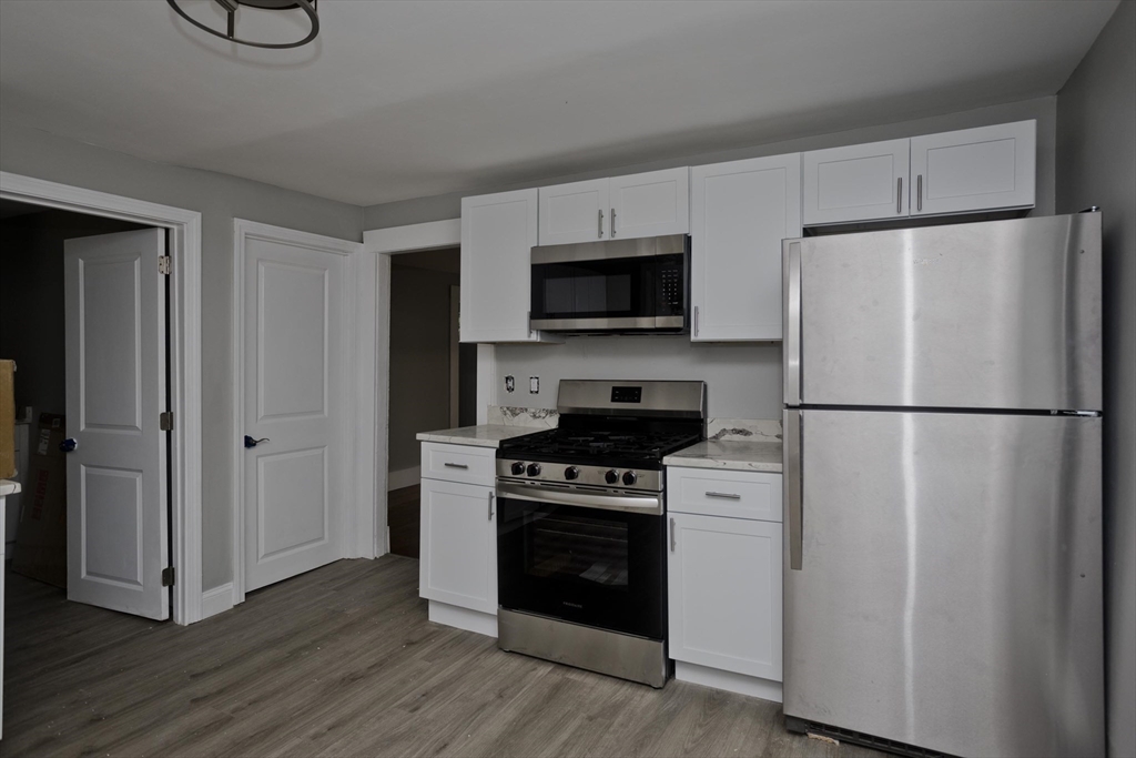 293-295 Water Street Springfield, MA 01151 - Photo 26 of 36 a kitchen with a refrigerator stove and microwave