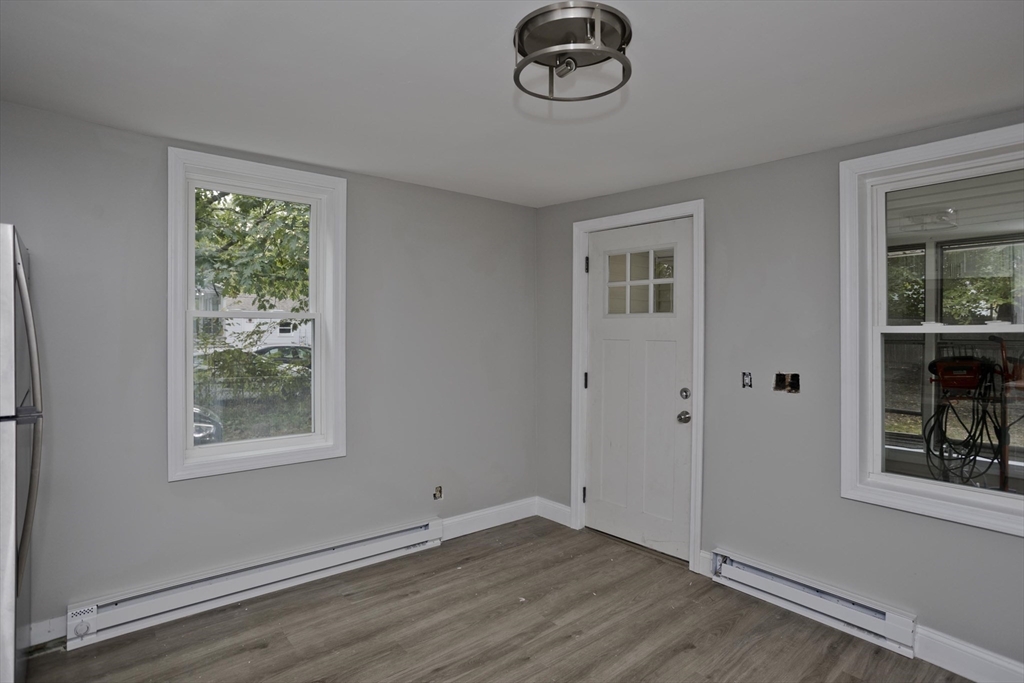 293-295 Water Street Springfield, MA 01151 - Photo 27 of 36 a view of an empty room with a window and wooden floor