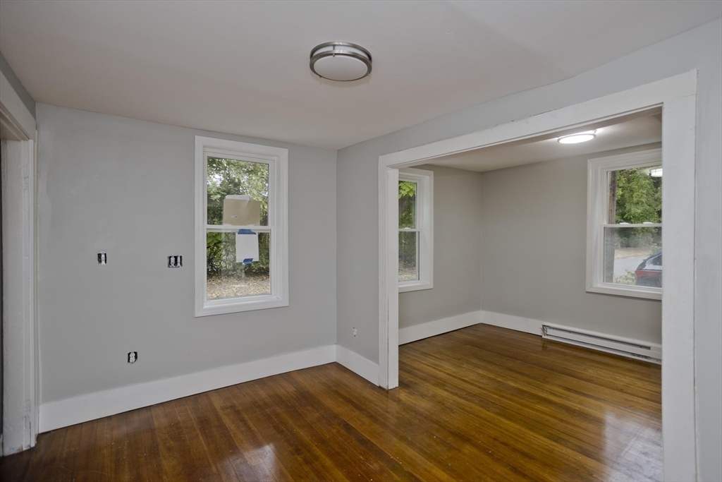 293-295 Water Street Springfield, MA 01151 - Photo 29 of 36 a view of an empty room with wooden floor and a window