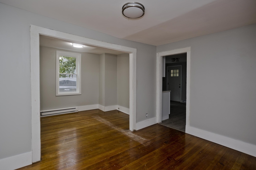 293-295 Water Street Springfield, MA 01151 - Photo 30 of 36 an empty room with wooden floor and windows