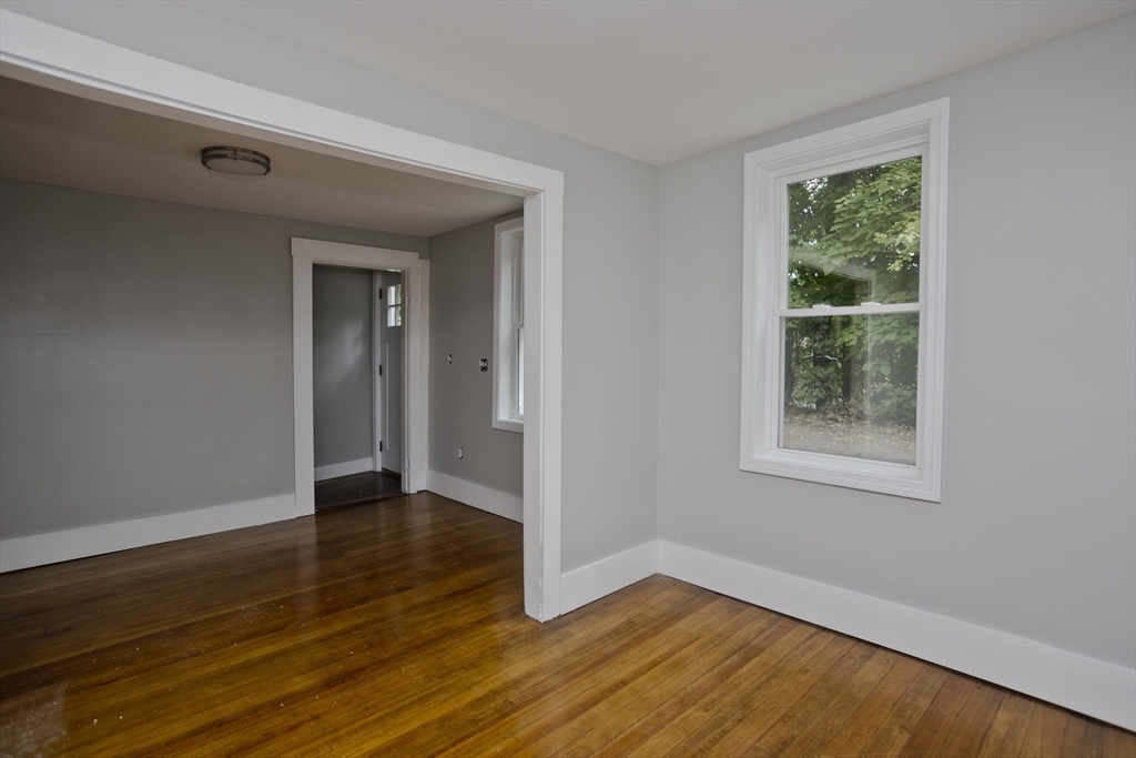 293-295 Water Street Springfield, MA 01151 - Photo 32 of 36 a view of an empty room with wooden floor and a window