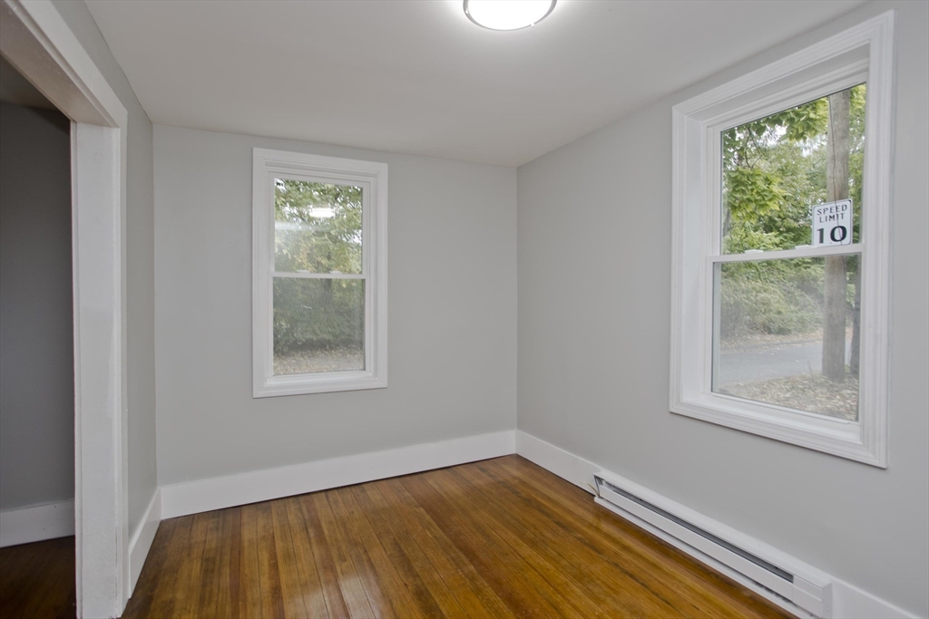 293-295 Water Street Springfield, MA 01151 - Photo 33 of 36 a view of an empty room with wooden floor and a window