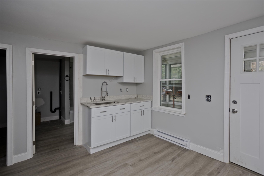 293-295 Water Street Springfield, MA 01151 - Photo 6 of 36 a kitchen with granite countertop white cabinets and white appliances
