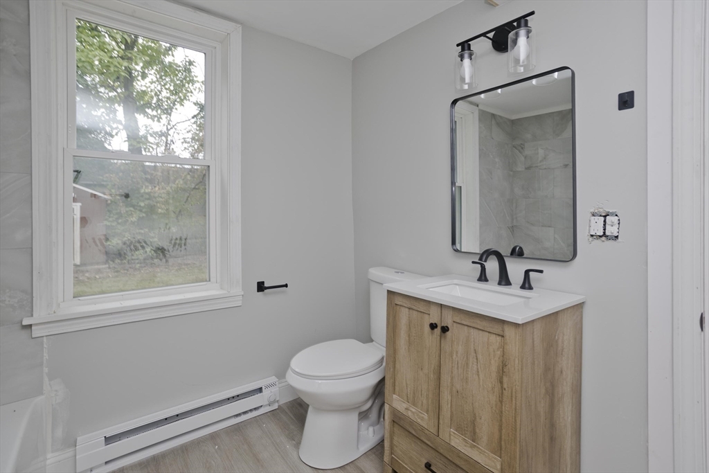 293-295 Water Street Springfield, MA 01151 - Photo 7 of 36 a bathroom with a toilet a sink and mirror