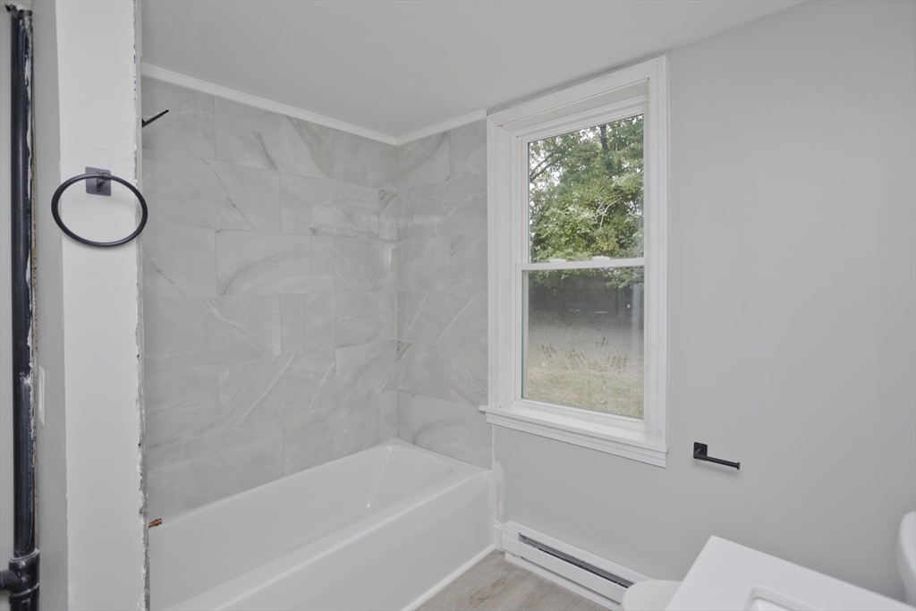 293-295 Water Street Springfield, MA 01151 - Photo 8 of 36 a bathroom with a bath tub and a window