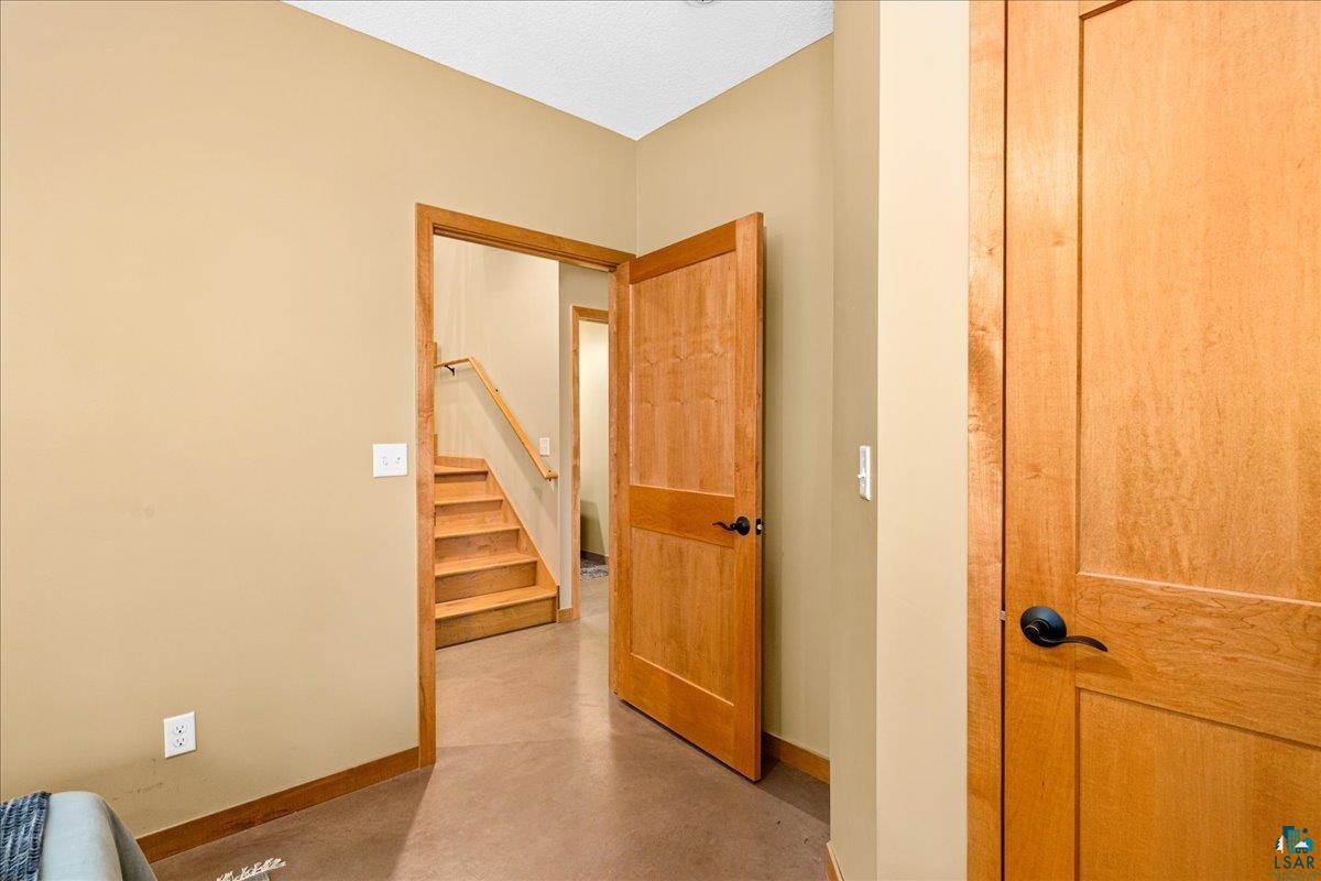 92598 Spells Road Sturgeon Lake, MN 55783 - Photo 32 of 60 Hallway with baseboards and concrete floors
