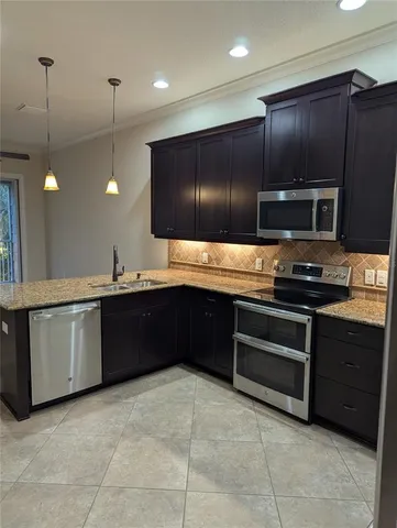 a kitchen with a sink and an oven
