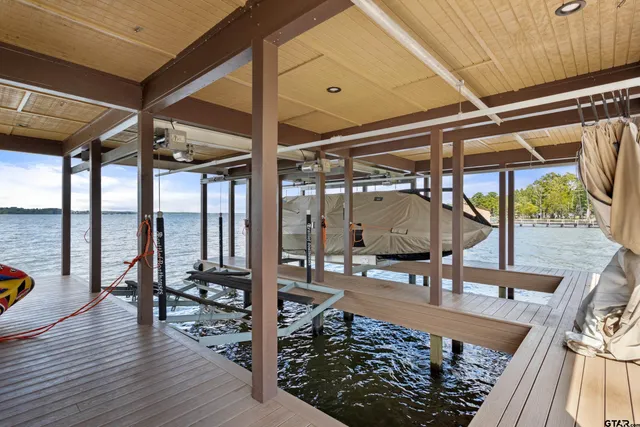 a spacious bedroom with a bed and large windows