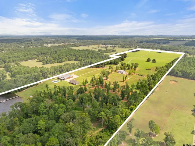 a view of a house with pool and a yard