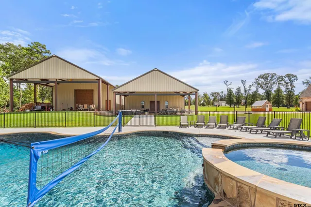 a view of a swimming pool with a yard