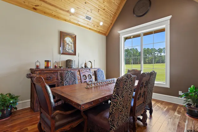 a bedroom with a bed and a flat tv screen on dresser
