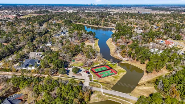 an aerial view of residential houses with outdoor space and swimming pool