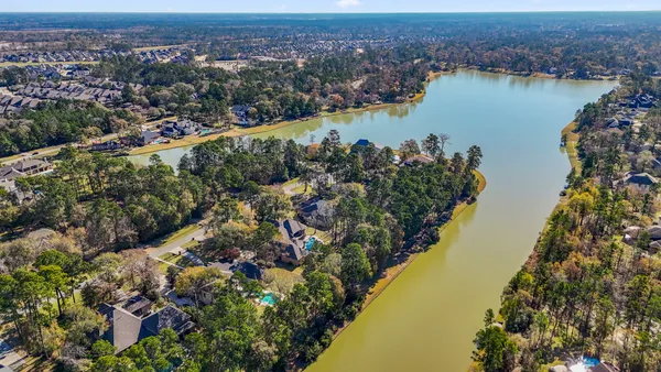 an aerial view of a houses with swimming pool