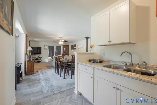 a kitchen with a refrigerator cabinets and wooden floor