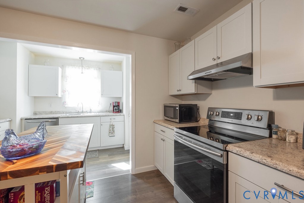 19001 Old Stage Road Dinwiddie, VA 23841 - Photo 26 of 84 a kitchen with stainless steel appliances granite countertop a stove a sink and a refrigerator