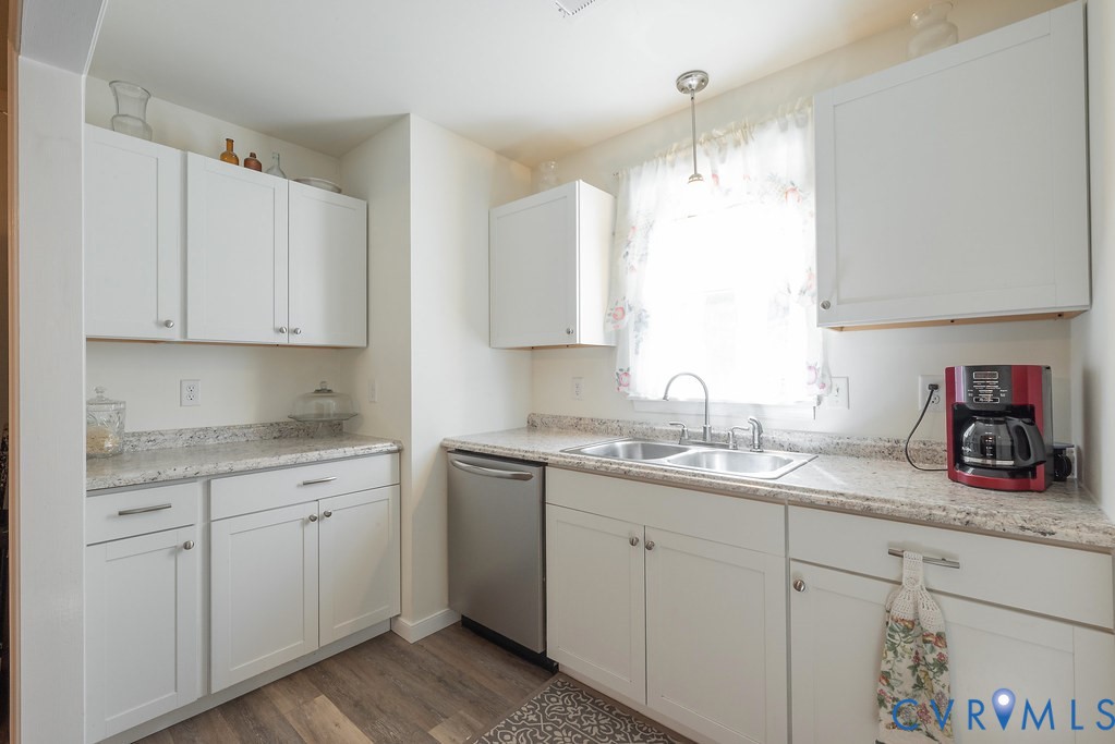 19001 Old Stage Road Dinwiddie, VA 23841 - Photo 27 of 84 a kitchen with a sink dishwasher and white cabinets