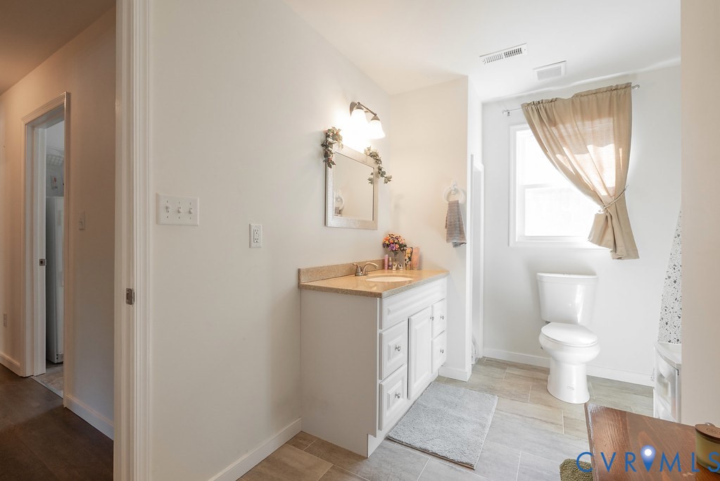 19001 Old Stage Road Dinwiddie, VA 23841 - Photo 34 of 84 a bathroom with a sink a toilet and a mirror