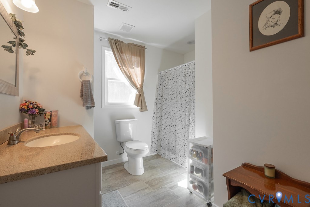 19001 Old Stage Road Dinwiddie, VA 23841 - Photo 35 of 84 a bathroom with a toilet sink and mirror