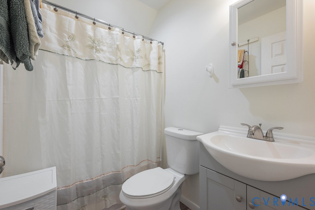 19001 Old Stage Road Dinwiddie, VA 23841 - Photo 40 of 84 a white toilet sitting next to a white sink and curtain