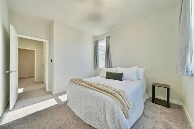 a bedroom with a bed and a mirror