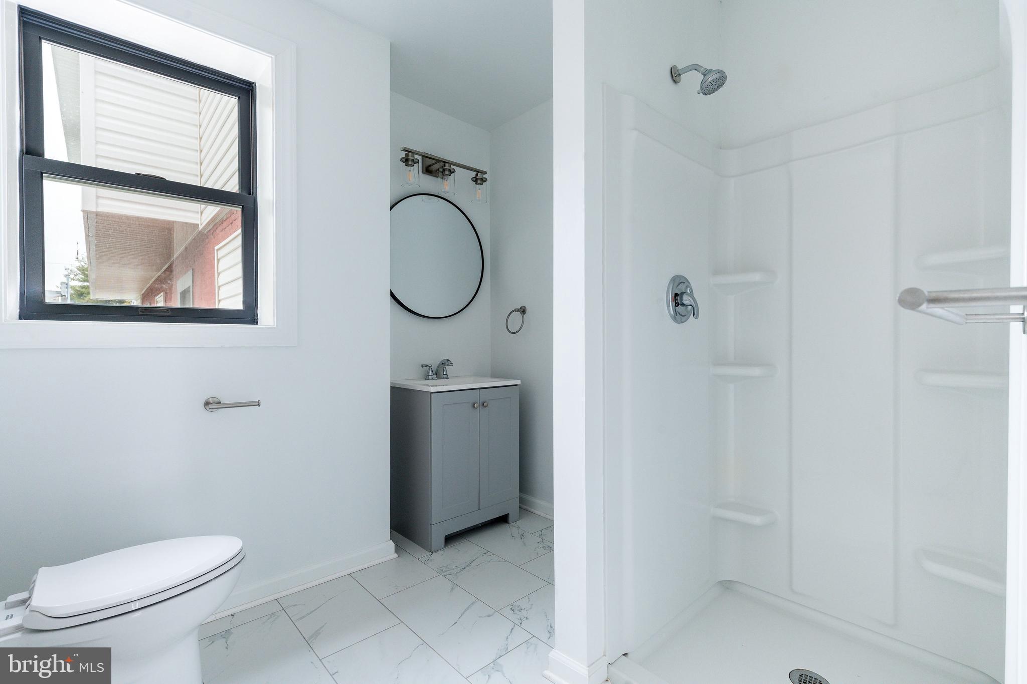 32 East Elm Street Norristown, PA 19401 - Photo 26 of 65 a bathroom with a toilet sink and mirror