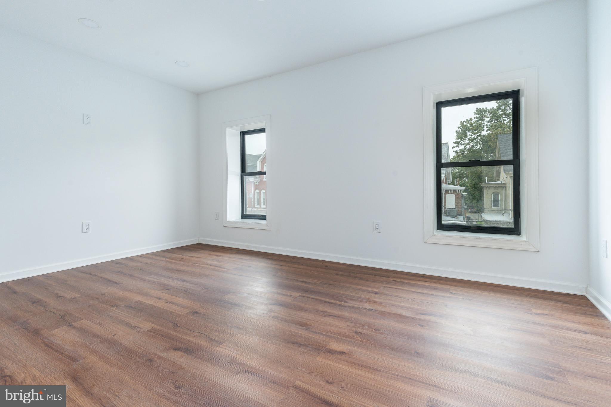 32 East Elm Street Norristown, PA 19401 - Photo 35 of 65 a view of an empty room with wooden floor and a window