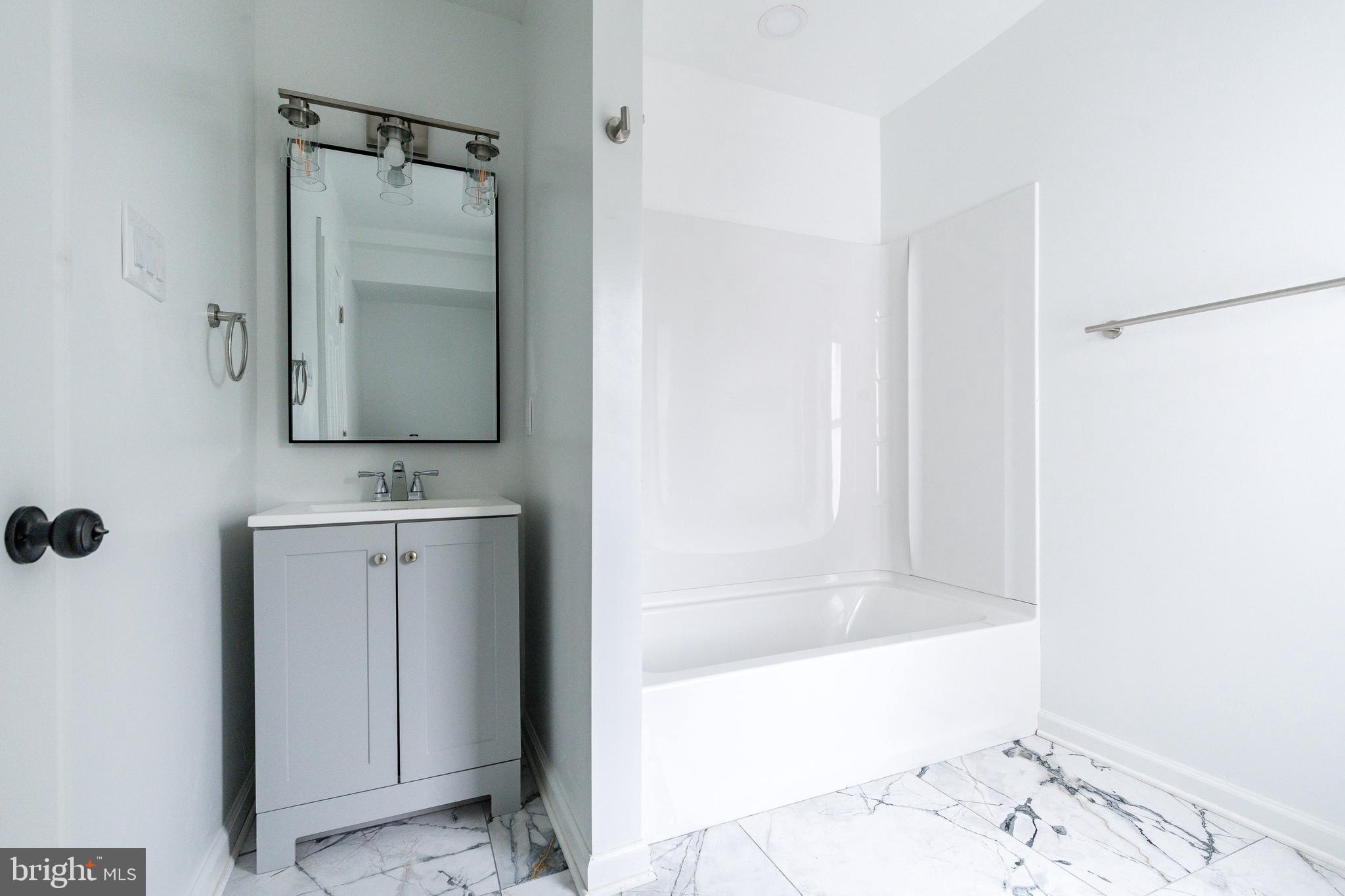 32 East Elm Street Norristown, PA 19401 - Photo 37 of 65 a bathroom with a bathtub and a sink